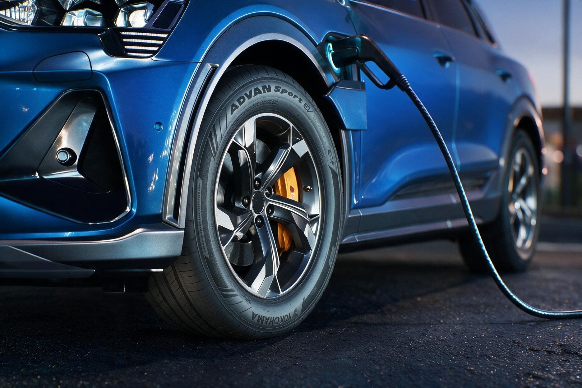 A blue electric vehicle is charging at the station.